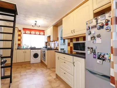 a kitchen with a refrigerator and a dishwasher at 21 Crossways in Clacton-on-Sea
