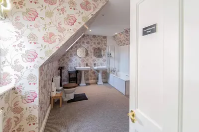 a bathroom with a sink and a toilet in a room at Butley Priory Farmhouse in Woodbridge