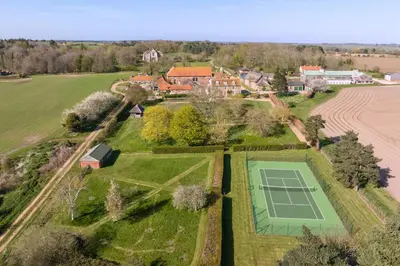 an overhead view of a tennis court in a field at Butley Priory Farmhouse in Woodbridge