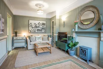 a living room with a couch and a tv at Villa Verde in Aldeburgh