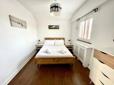 a small bedroom with a bed and a window at The Cart Lodge at Lee Wick Farm Cottages & Glamping in Saint Osyth
