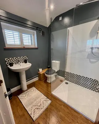 a bathroom with a shower and a sink at The Cart Lodge at Lee Wick Farm Cottages & Glamping in Saint Osyth