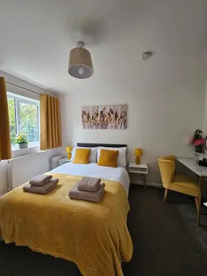 a bedroom with a bed with two towels on it at One Bed Apartment Stevenage in Stevenage