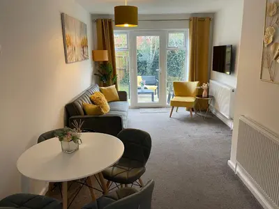 a living room with a table and a couch at One Bed Apartment Stevenage in Stevenage