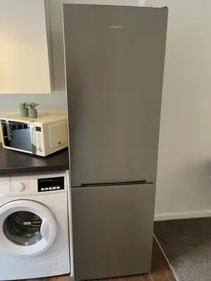 a refrigerator in a kitchen next to a microwave at One Bed Apartment Stevenage in Stevenage