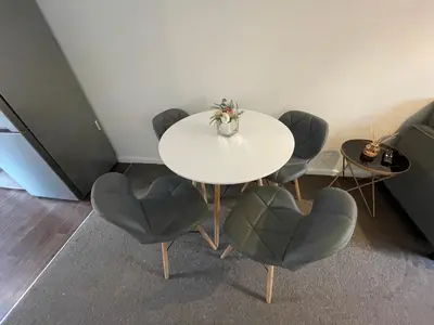 a white table and chairs in a room at One Bed Apartment Stevenage in Stevenage