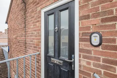 a black door on the side of a brick building at Lovely 2 bedroom apartment - ideal location in Cambridge