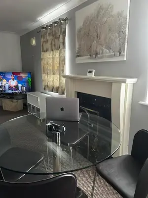 a living room with a glass table with a laptop at Ipswich-Luxury-Self Catering-Town Centre-Parking in Ipswich