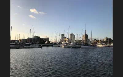 a group of boats docked in a harbor with a city at Ipswich-Luxury-Self Catering-Town Centre-Parking in Ipswich