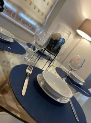 a table with plates and forks and glasses on it at Ipswich-Luxury-Self Catering-Town Centre-Parking in Ipswich