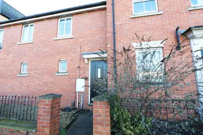a red brick building with a door and a fence at Ipswich-Luxury-Self Catering-Town Centre-Parking in Ipswich