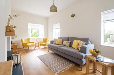 a living room with a couch and a table at The Lodge, Aldringham in Aldringham