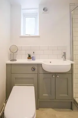 a bathroom with a sink and a toilet at The Lodge, Aldringham in Aldringham
