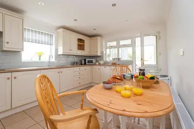 a kitchen with a wooden table with fruit on it at The Lodge, Aldringham in Aldringham