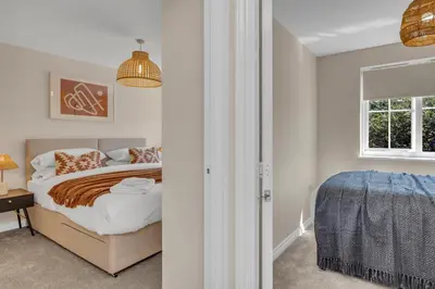 a bedroom with a bed and a window at The Grange Luxe3, 4 Bedroom House,5-beds,Spacious,contractor,family,Internet,free parking,group,study,relocation,easily accessible in Ipswich,Kesgrave in Ipswich