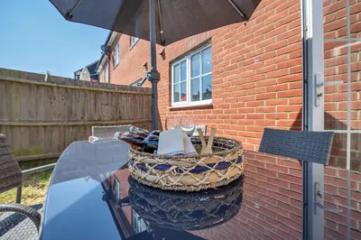 a basket sitting on a table with an umbrella at The Grange Luxe3, 4 Bedroom House,5-beds,Spacious,contractor,family,Internet,free parking,group,study,relocation,easily accessible in Ipswich,Kesgrave in Ipswich