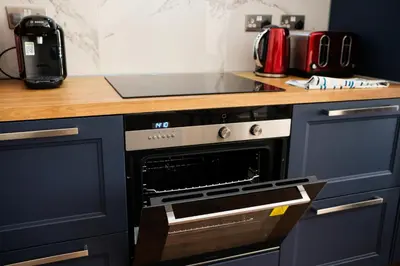 a kitchen with a stove top oven in a kitchen at Modern accomodation in Westcliff-On-Sea in Westcliff On Sea
