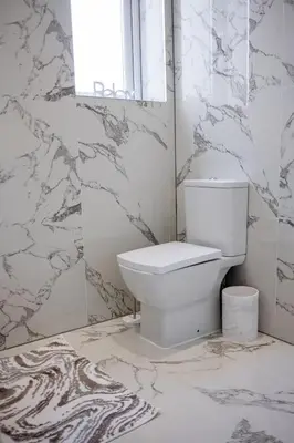 a white bathroom with a toilet and a window at Modern accomodation in Westcliff-On-Sea in Westcliff On Sea