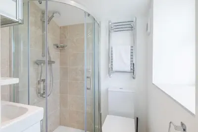 a bathroom with a shower and a toilet and a sink at Refurbished High Spec CENTRAL Family Home in Cambridge
