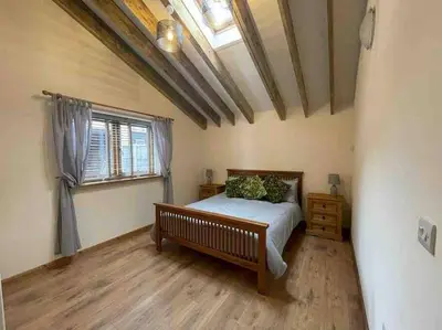 a bedroom with a bed and a window at Charming Norfolk Barn Conversion in Barnham Broom in Norwich