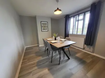 a dining room with a table and chairs at Jersey Cottage in Horseheath