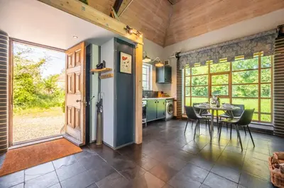 a kitchen and dining room with a table and chairs at Ultimate Constable Country rural retreat - The Pump House in Colchester