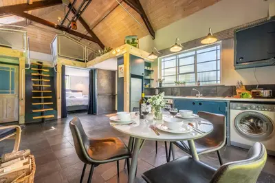 a kitchen with a table and chairs in a room at Ultimate Constable Country rural retreat - The Pump House in Colchester
