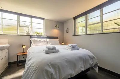 a bedroom with a white bed with towels on it at Ultimate Constable Country rural retreat - The Pump House in Colchester