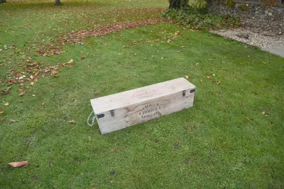 a wooden box sitting on the grass at The Mill B&B in Thetford