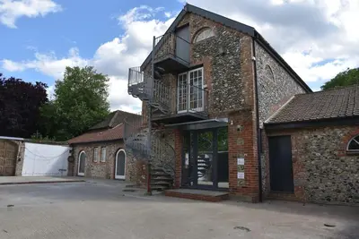 a brick building with a staircase on the side of it at The Mill B&B in Thetford
