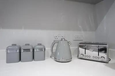 a kitchen counter with a tea kettle and other appliances at S/KING BED ONE BEDROOM FLAT in Brentwood