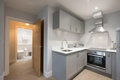 a white kitchen with a sink and a stove at S/KING BED ONE BEDROOM FLAT in Brentwood