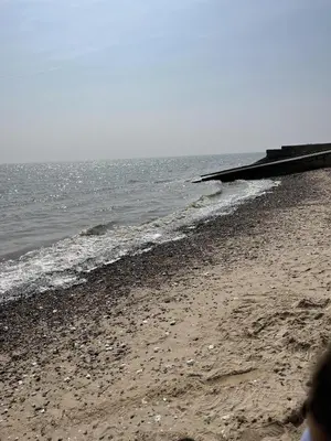 a sandy beach with the ocean in the background at Coopers Beach 3-Bed Caravan Sleeps 8 & Pets Ok in Colchester