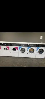 a row of washers and dryers in a store at Coopers Beach 3-Bed Caravan Sleeps 8 & Pets Ok in Colchester