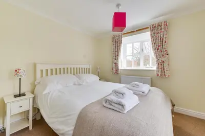 two beds in a bedroom with towels on top of it at 3 Bed in Aldeburgh oc-chfc in Aldeburgh