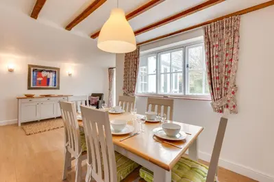 a dining room with a wooden table and chairs at 3 Bed in Aldeburgh oc-chfc in Aldeburgh