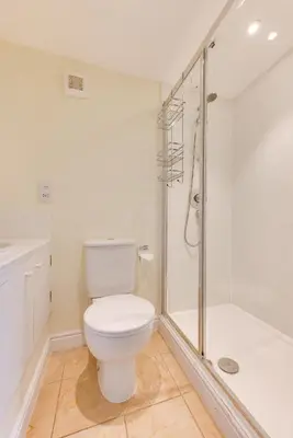 a white bathroom with a toilet and a shower at 3 Bed in Aldeburgh oc-chfc in Aldeburgh
