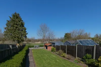 a garden with a fence and some buildings at 3 Bed in Middleton oc-fdp in Middleton