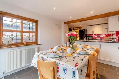 a dining room with a table with chairs and a kitchen at 3 Bed in Middleton oc-fdp in Middleton