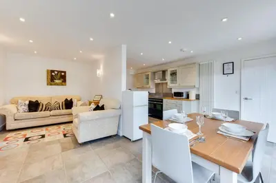 a kitchen and living room with a table and a couch at 2 Bed in Sudbury oc-clo in Sudbury