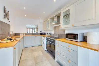 a kitchen with white cabinets and a stove top oven at 2 Bed in Sudbury oc-clo in Sudbury