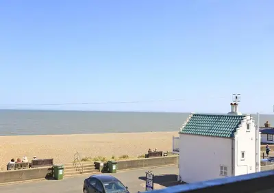 a building on the beach with the ocean in the background at 3 Bed in Aldeburgh oc-marg in Aldeburgh