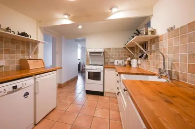 a kitchen with white cabinets and a stove top oven at 3 Bed in Aldeburgh oc-marg in Aldeburgh