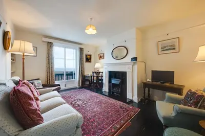 a living room with a couch and a fireplace at 3 Bed in Aldeburgh oc-marg in Aldeburgh