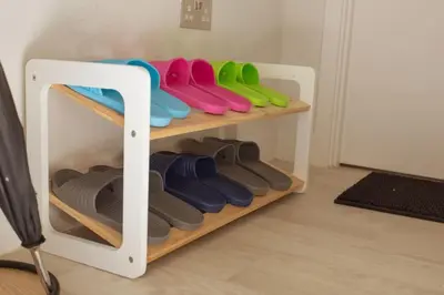 a shelf with a row of colorful shoes on it at Luxury Ensuite Room 2 Minutes from Cambridge Station in Cambridge