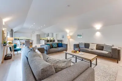 a living room with two couches and a table at 3 Bed in Snape oc-1wadd in Snape