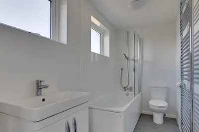 a white bathroom with a sink and a toilet at 3 Bed in Aldeburgh oc-10nw in Aldeburgh