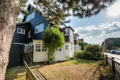 a black and white house with a tree at 5 Bed in Thorpeness oc-whin2 in Thorpeness