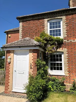 a brick house with a white door and windows at 3 Bed in Belchamp Otten oc-2mf in Belchamp Otten