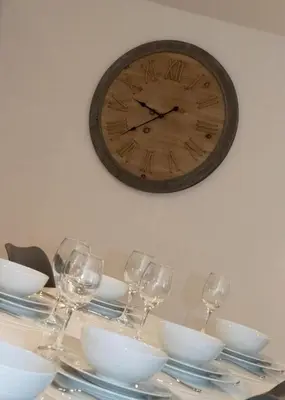 a table with wine glasses and a clock on the wall at 3 Bed in Snape oc-2wadd in Snape